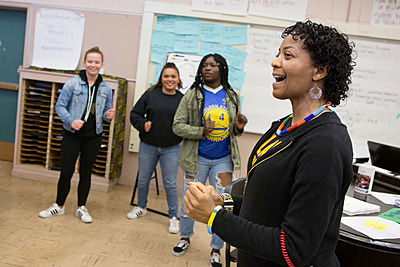 High school students dancing in classroom