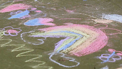 Children's chalk drawings on pavement