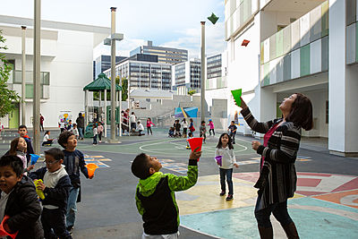 Children playing with chaperone at recess